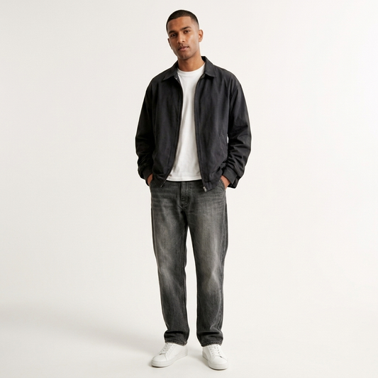 Front view of men's dark grey relaxed fit jeans on a model