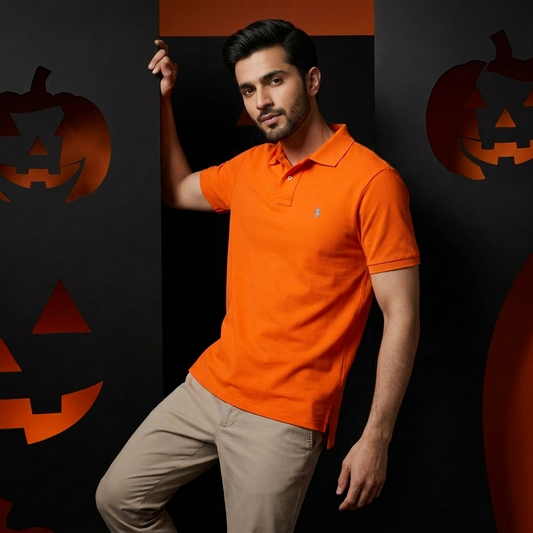 Model wearing a Sailing Orange Ralph Lauren polo shirt with white trousers
