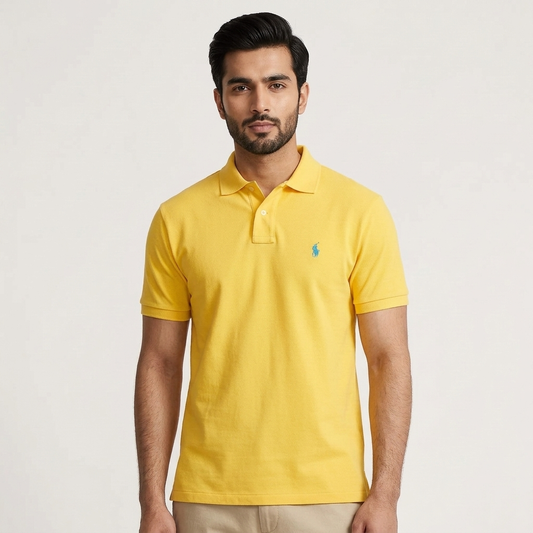 Model wearing a yellow Ralph Lauren polo shirt with white trousers