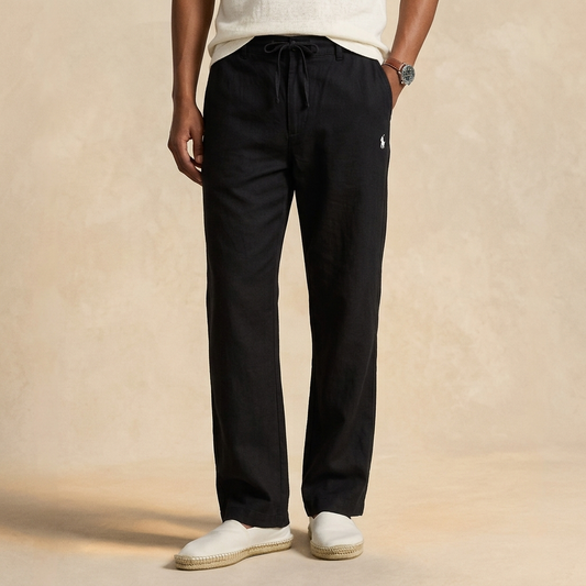 Man wearing black Remi cotton relaxed fit trousers with white shirt