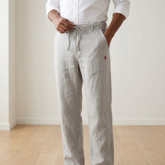 Man wearing light silver Remi cotton relaxed fit trousers with white shirt
