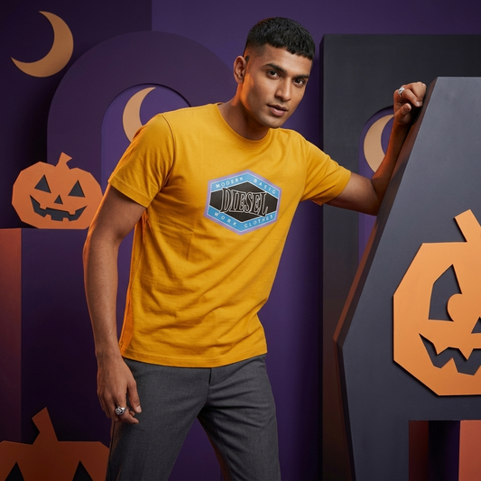 Model wearing mustard yellow Diesel DTF print t-shirt