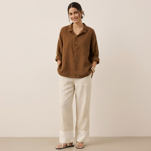 Model wearing a brown relaxed collared half-placket shirt with three-quarter sleeves