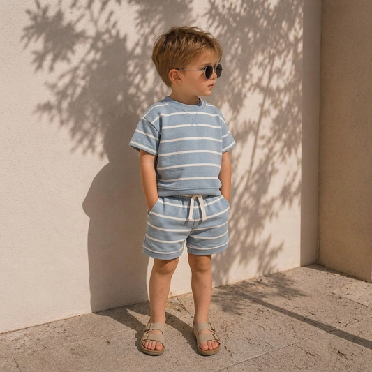 Child wearing a blue striped t-shirt and matching shorts set