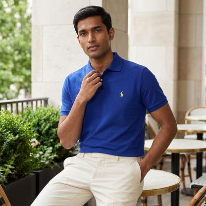 Model wearing a Fall Royal Ralph Lauren polo shirt in a bright setting
